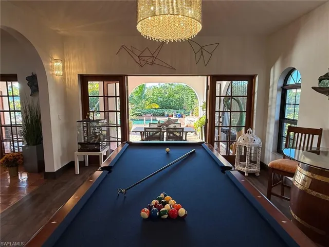 Recreation room featuring arched walkways and pool table