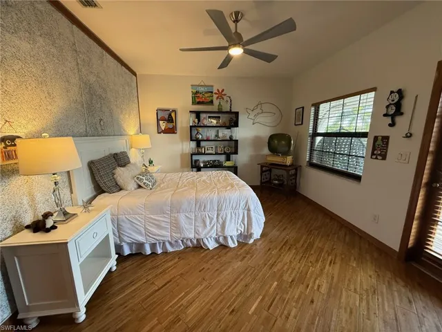 Bedroom with wood finished floors and ceiling fan