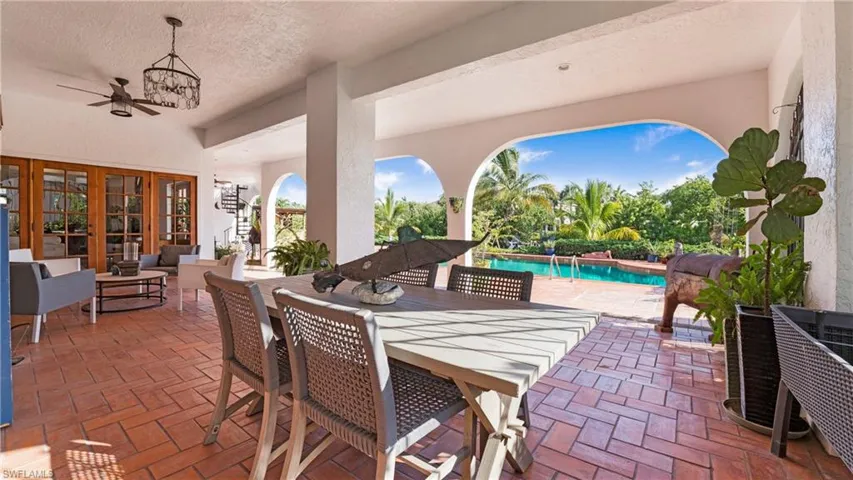 View of patio with ceiling fan, an outdoor pool, french doors, outdoor dining area, and an outdoor hangout area