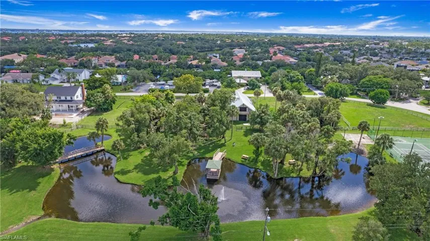 Aerial overview of property's location with a nearby body of water and nearby suburban area