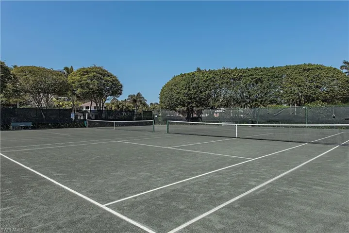 View of tennis court featuring community basketball court
