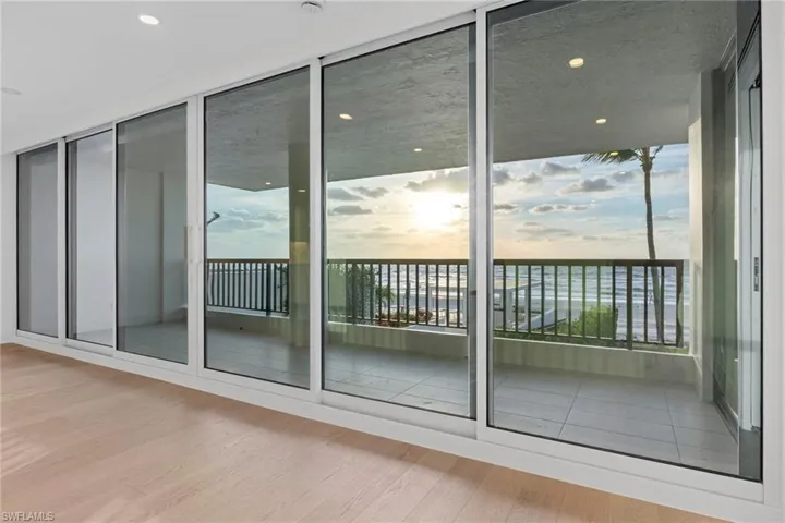 Entryway featuring wood finished floors, plenty of natural light, and a wall of windows