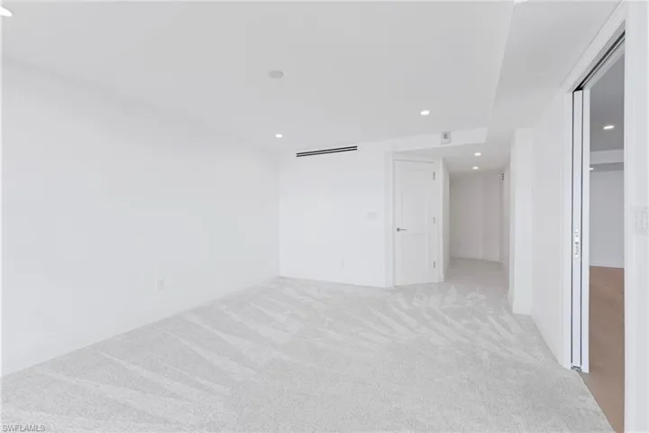 Unfurnished bedroom featuring recessed lighting and light carpet