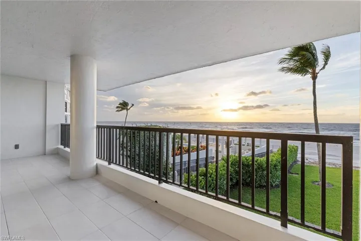 Balcony with view of water and beach