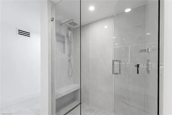 Bathroom featuring a marble finish shower