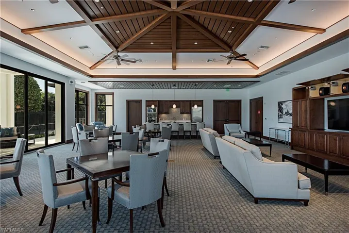 Common area with coffered ceiling and a high ceiling