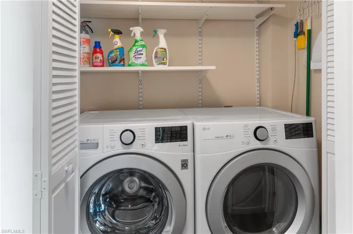 Washroom with washing machine and clothes dryer