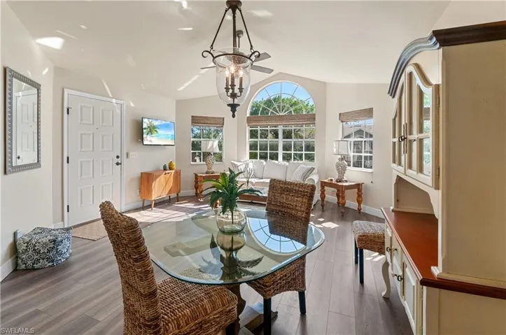 Dining room featuring a chandelier, light hardwood / wood-style flooring, and lofted ceiling