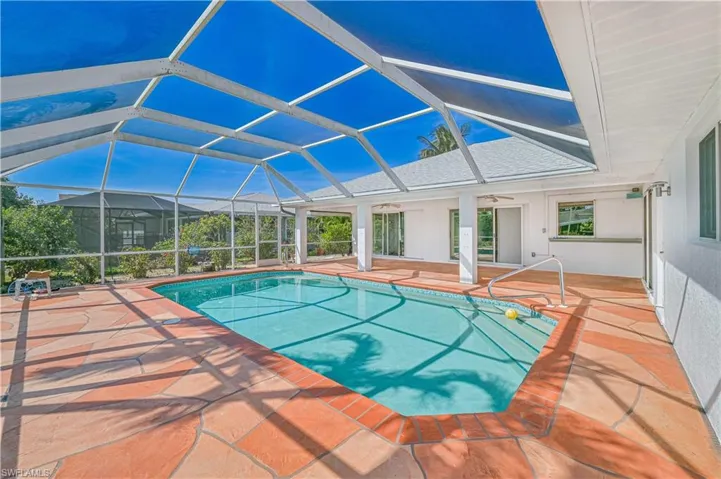 Pool featuring ceiling fan, a patio area, and a lanai