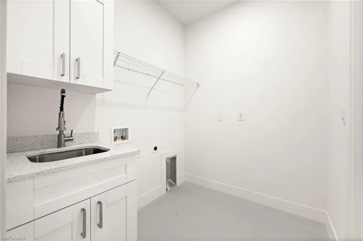 Laundry area featuring cabinet space, hookup for an electric dryer, and hookup for a washing machine