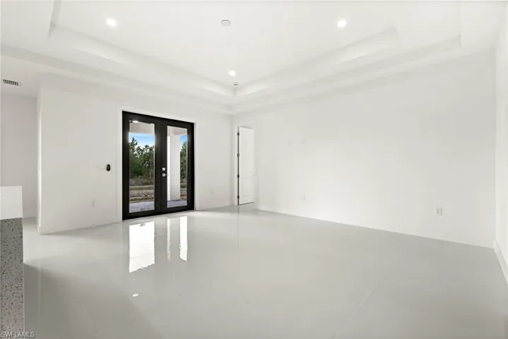 Unfurnished room with french doors, recessed lighting, and light tile patterned floors