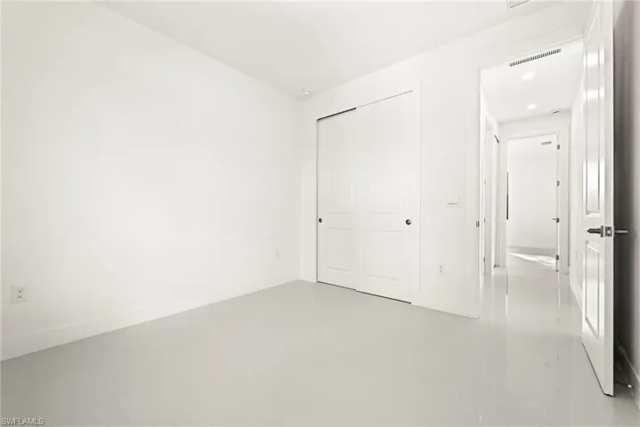 Unfurnished bedroom with a closet and baseboards