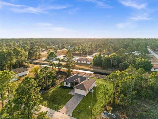 Aerial view of residential area with a heavily wooded area