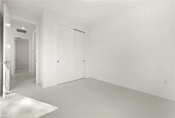 Unfurnished bedroom featuring a closet and light tile patterned flooring