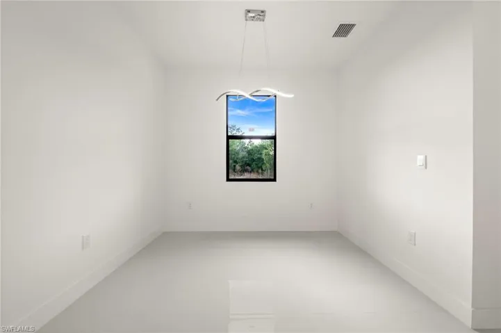 Empty room featuring baseboards