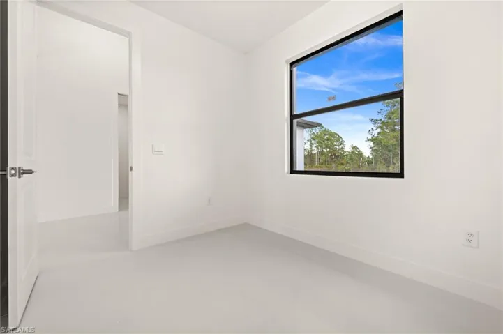 Unfurnished room featuring baseboards