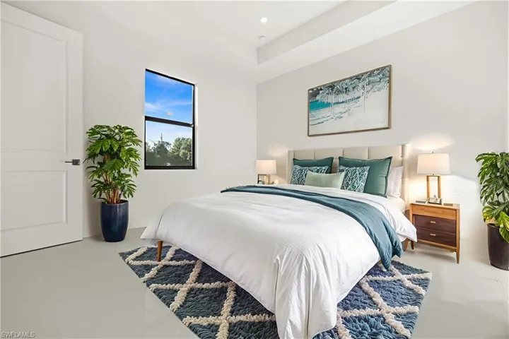 Bedroom with concrete floors and recessed lighting