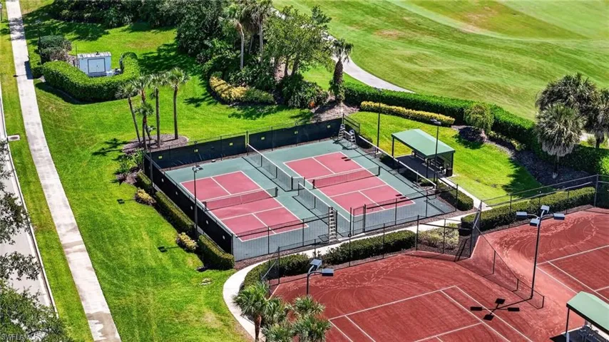 Recreational sports complex featuring two hard-surface tennis courts and two additional hard-surface courts with a covered seating area