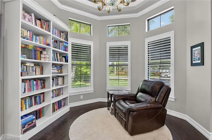 Built-in white shelving unit in a room with dark wood-finish flooring