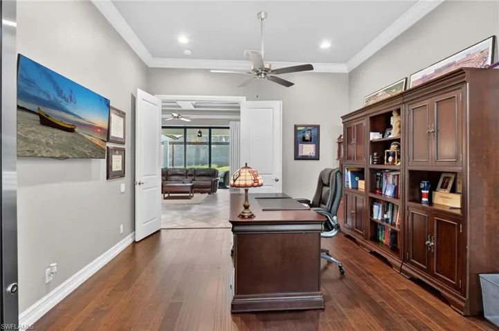 Private office space featuring wood-finish flooring, crown molding, a ceiling fan, and recessed lighting