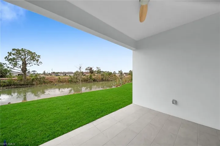 View of yard with a patio area and a water view