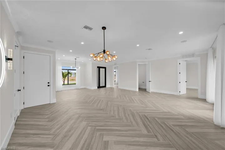 Empty room featuring recessed lighting, visible vents, and baseboards