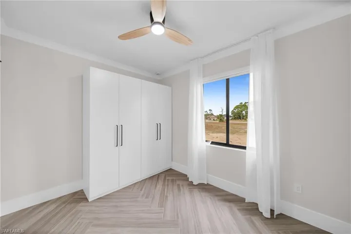 Unfurnished bedroom featuring a closet, baseboards, and a ceiling fan