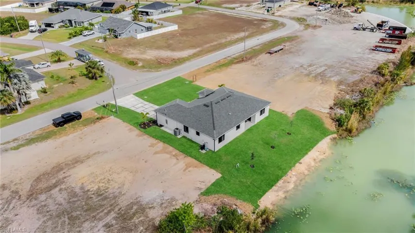 Birds eye view of property with a residential view and a water view