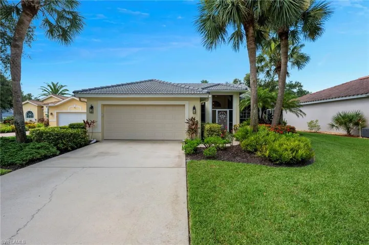 Single story home featuring stucco siding, driveway, a tile roof, a front yard, and an attached garage