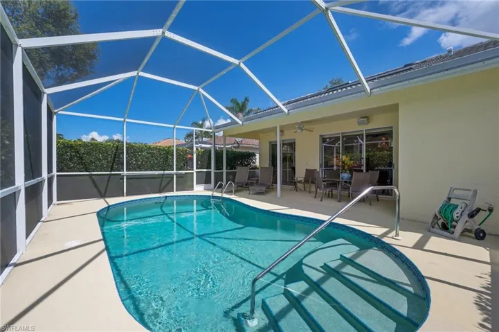 View of pool featuring a sunroom, a lanai, ceiling fan, and a patio area