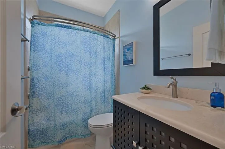Full bath featuring vanity and light tile patterned floors