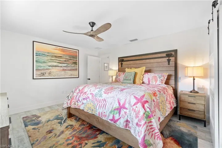 Bedroom with ceiling fan and wood-type flooring