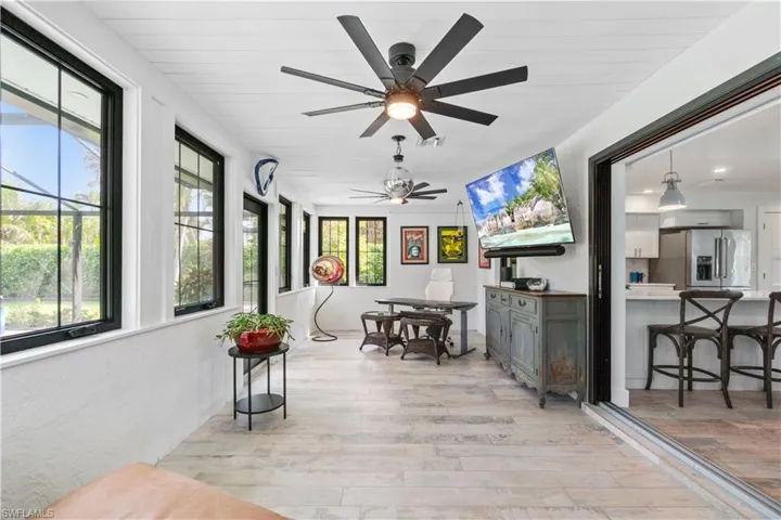Sunroom featuring ceiling fan