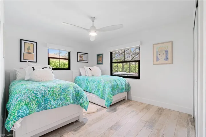 Bedroom with light hardwood / wood-style flooring and ceiling fan