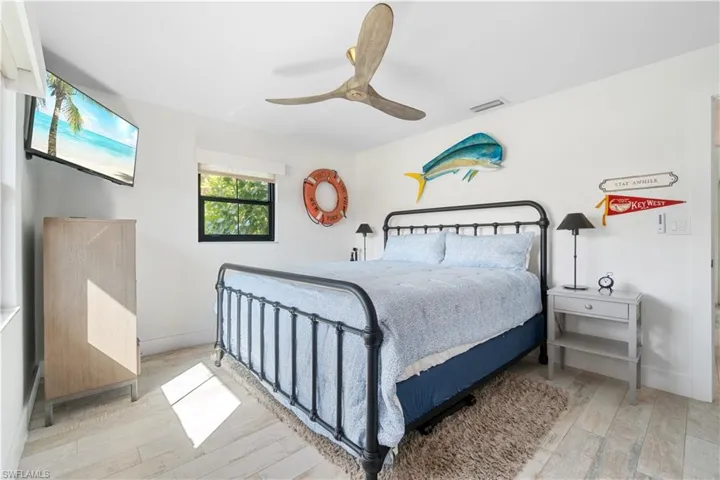 Bedroom with ceiling fan and light hardwood / wood-style flooring