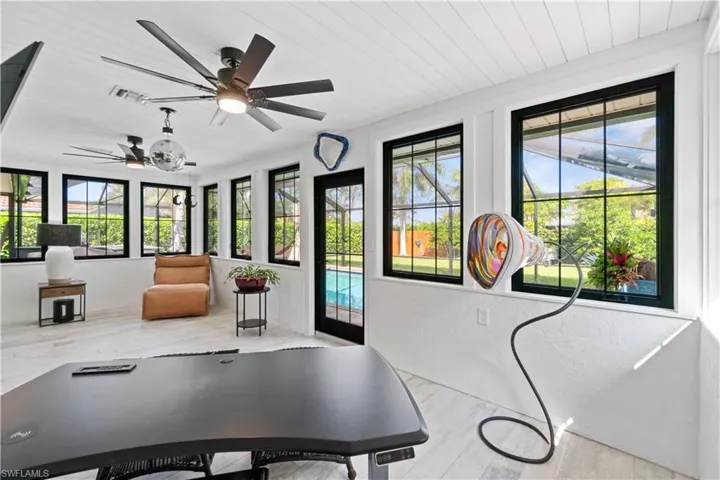Exercise area featuring wood ceiling and ceiling fan