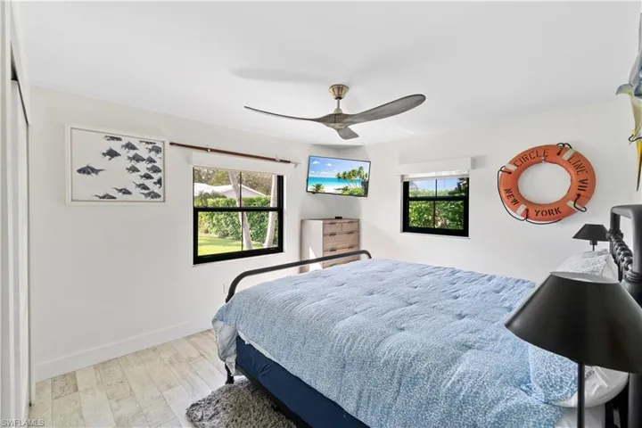 Bedroom with ceiling fan and light hardwood / wood-style flooring