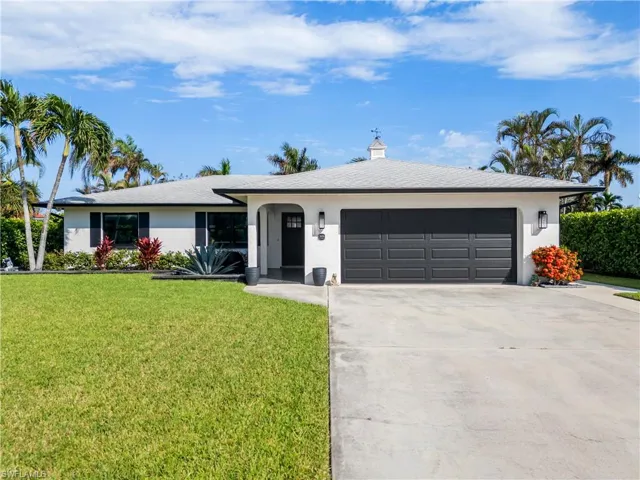 Ranch-style house with a front lawn and a garage