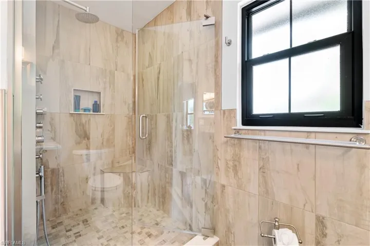 Bathroom featuring a shower with door