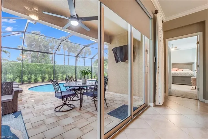 Covered pavered Lanai with TV, entirely screened in pool cage (newly screened 2024).