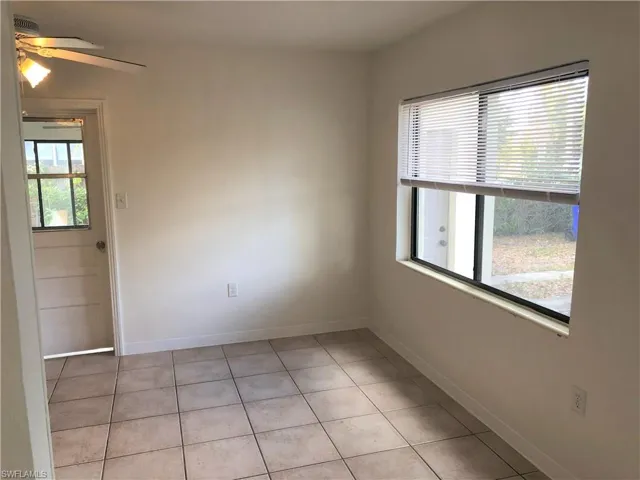 Unfurnished room with ceiling fan and light tile patterned floors