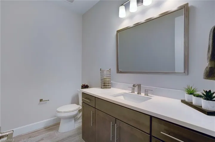 Bathroom featuring vanity and wood finished floors