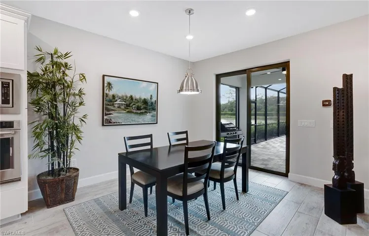 Dining area featuring light wood-style floors and recessed lighting