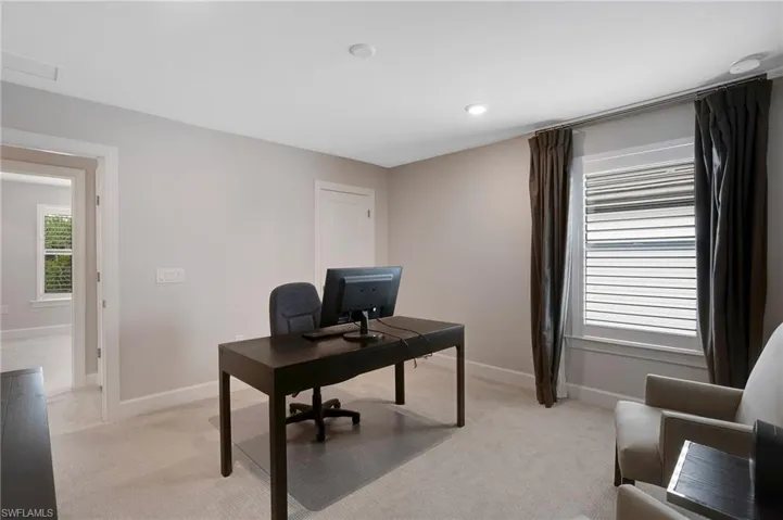 Office featuring light colored carpet and baseboards