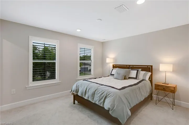 Bedroom featuring light colored carpet and recessed lighting