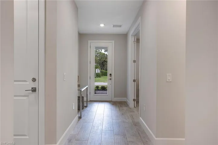 Doorway to outside featuring light wood-style floors and baseboards