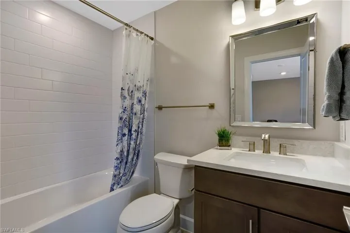 Bathroom with vanity and shower / tub combo