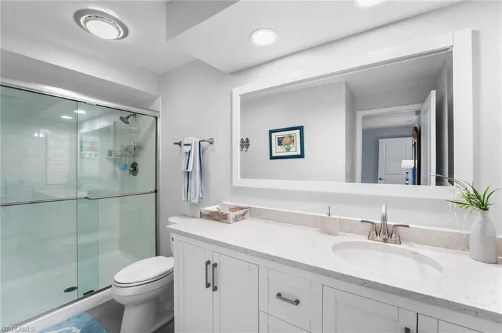 2nd bathroom is an ensuite off of the 2nd bedroom. Walk in shower, quartz countertops.