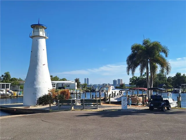 View of property's community featuring a boat dock and a water view