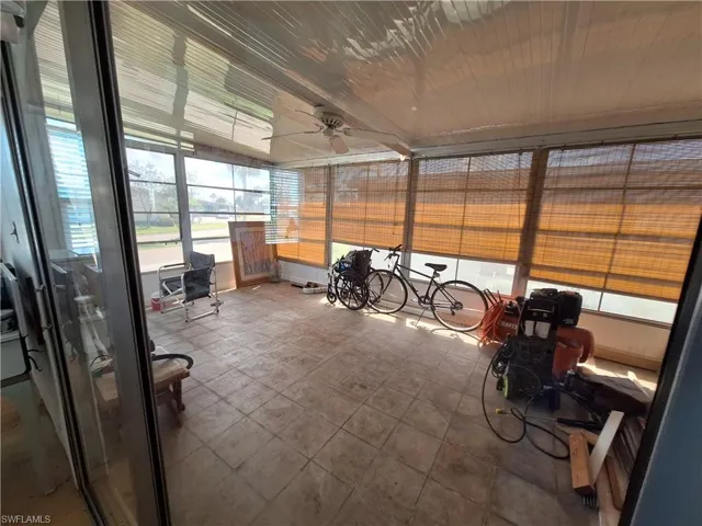 Sunroom featuring a ceiling fan
